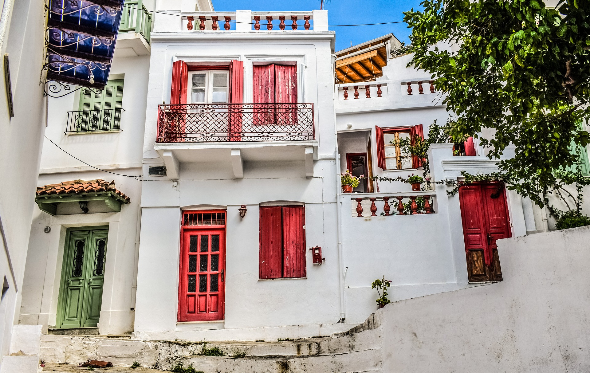 Bunte Häuser auf Skopelos Weiße Häuser mit bunten Türen und Fenstern
